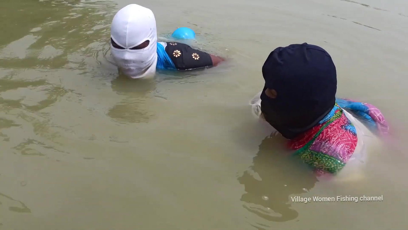 Village Masked Women Fishing in Dangerous Water