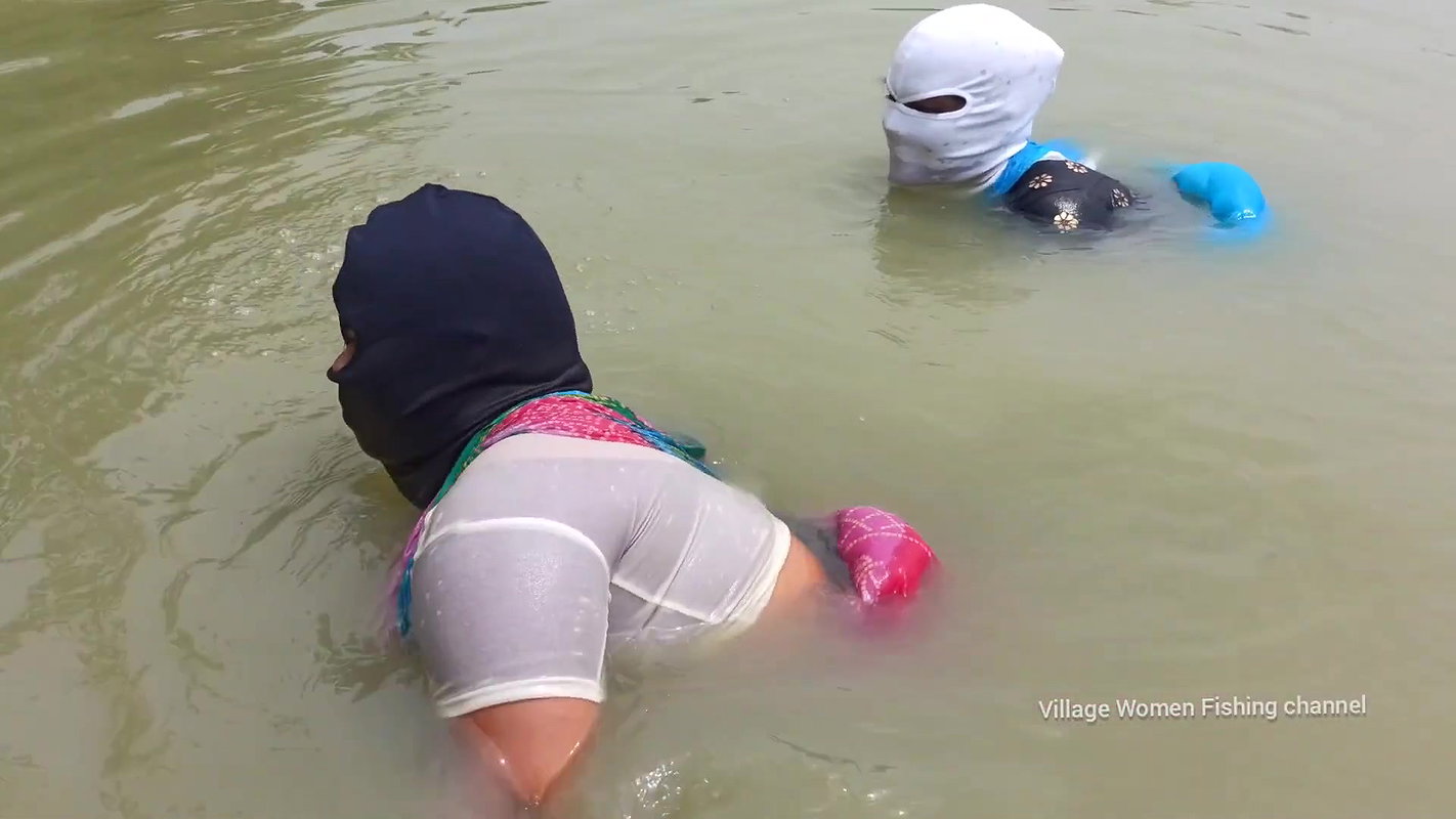 Village Masked Women Fishing in Dangerous Water