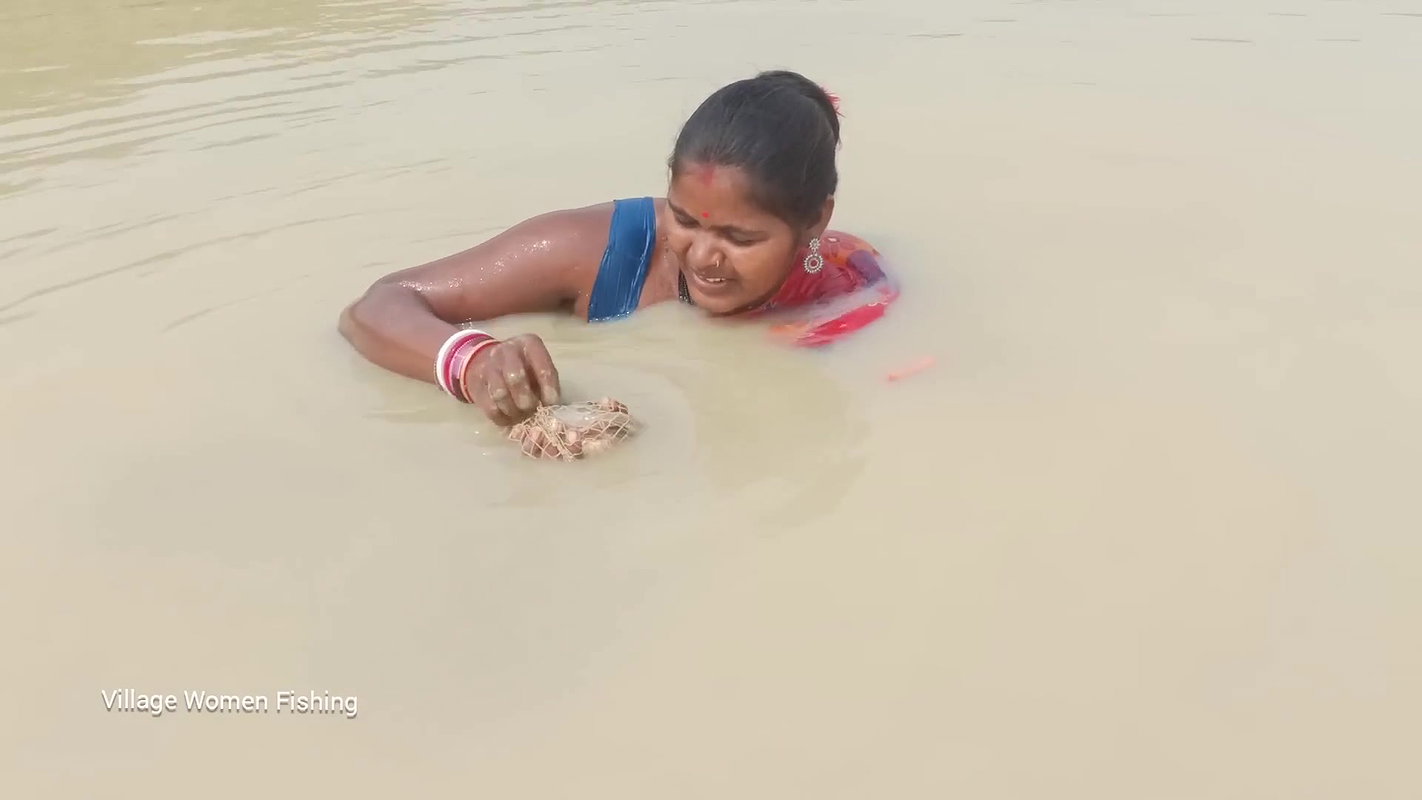 Village women catching lots of fish from Mud water