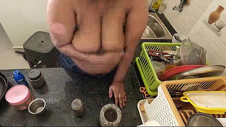 My girl friend massaging her boobs with oil in kitchen