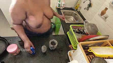 My girl friend massaging her boobs with oil in kitchen