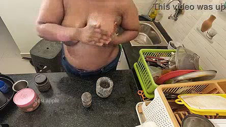 My girl friend massaging her boobs with oil in kitchen