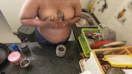 My girl friend massaging her boobs with oil in kitchen