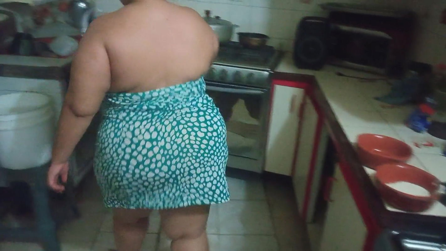 chubby stepmother in the kitchen preparing a delicious dinner