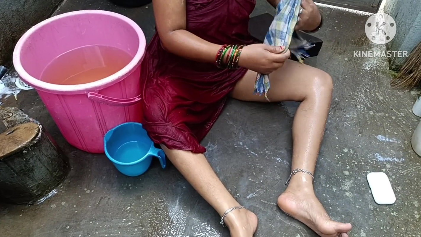 Indian housewife bathing with