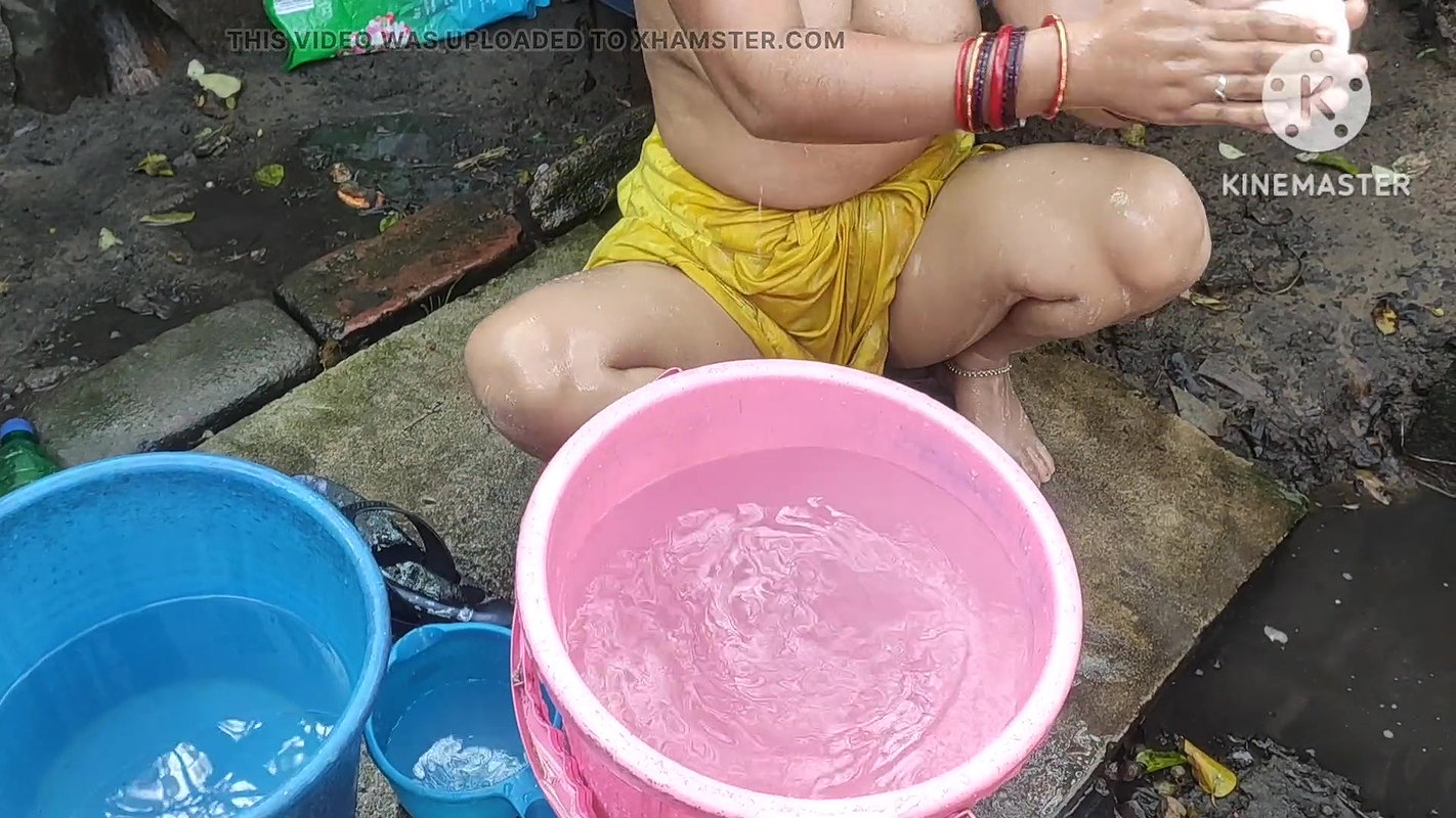 Indian bhabhi bathing outside with