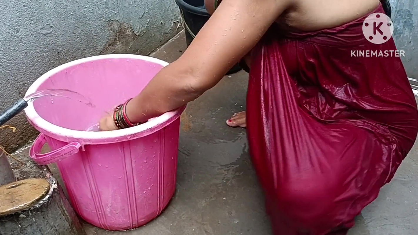 Indian housewife bathing with