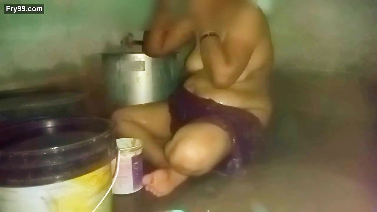 Indian aunty bathing in village home