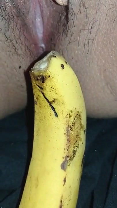 Indian girl playing with banana