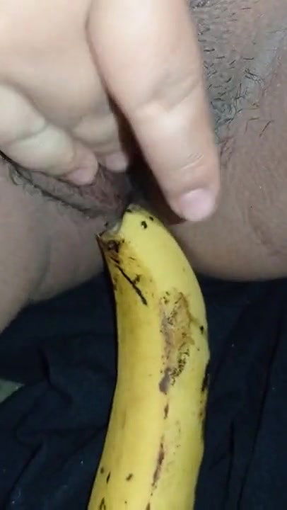 Indian girl playing with banana