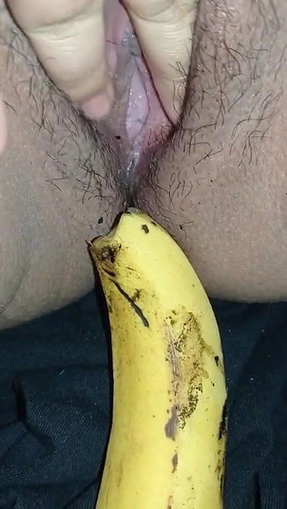 Indian girl playing with banana