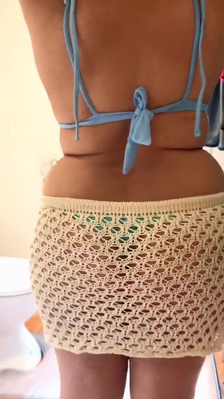 Dressing up in sexy and stylish bikini in the bathroom