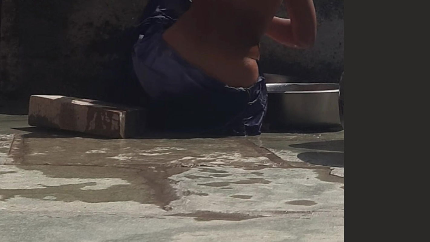 Desi sister-in-law is taking a bath in an open bathroom near the road on the edge of the forest on the farm