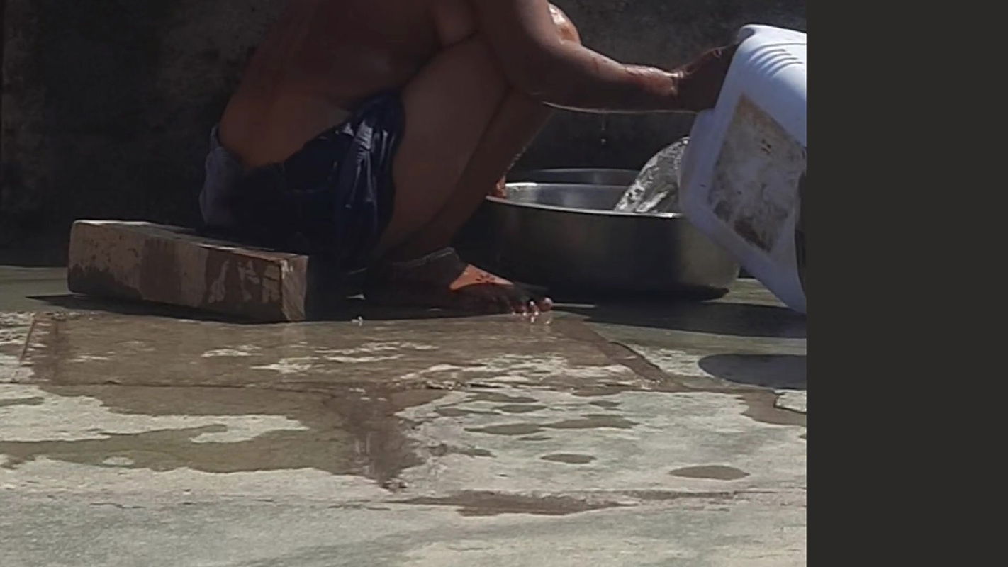 Desi sister-in-law is taking a bath in an open bathroom near the road on the edge of the forest on the farm