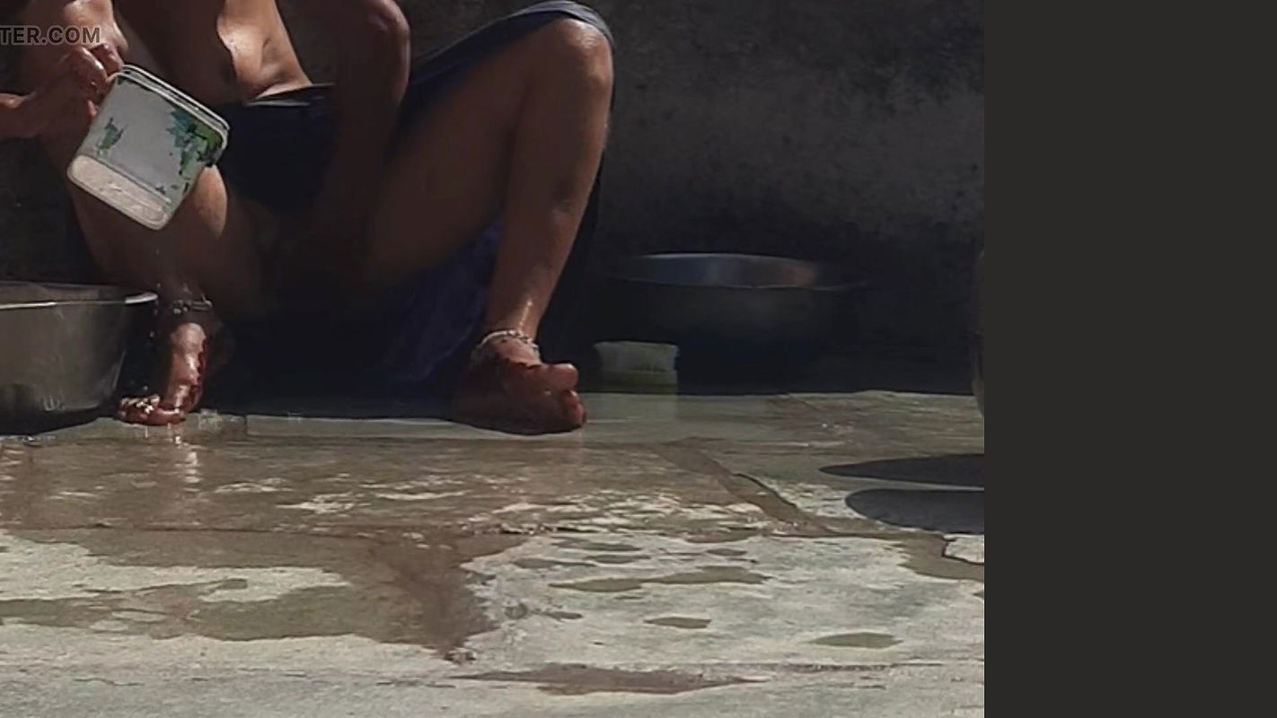 Desi sister-in-law is taking a bath in an open bathroom near the road on the edge of the forest on the farm