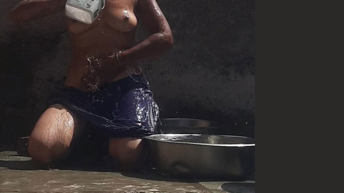 Desi sister-in-law is taking a bath in an open bathroom near the road on the edge of the forest on the farm