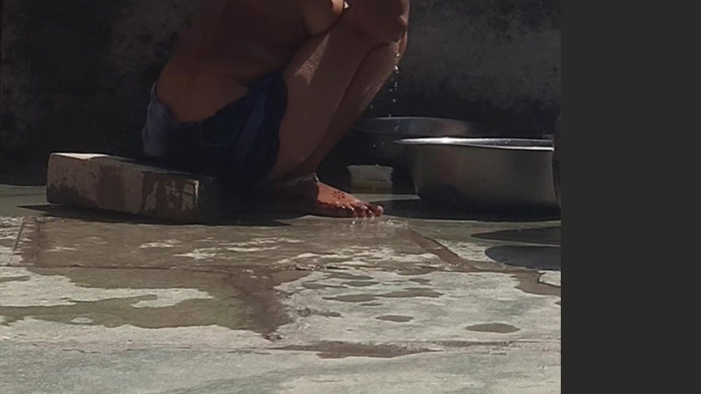 Desi sister-in-law is taking a bath in an open bathroom near the road on the edge of the forest on the farm