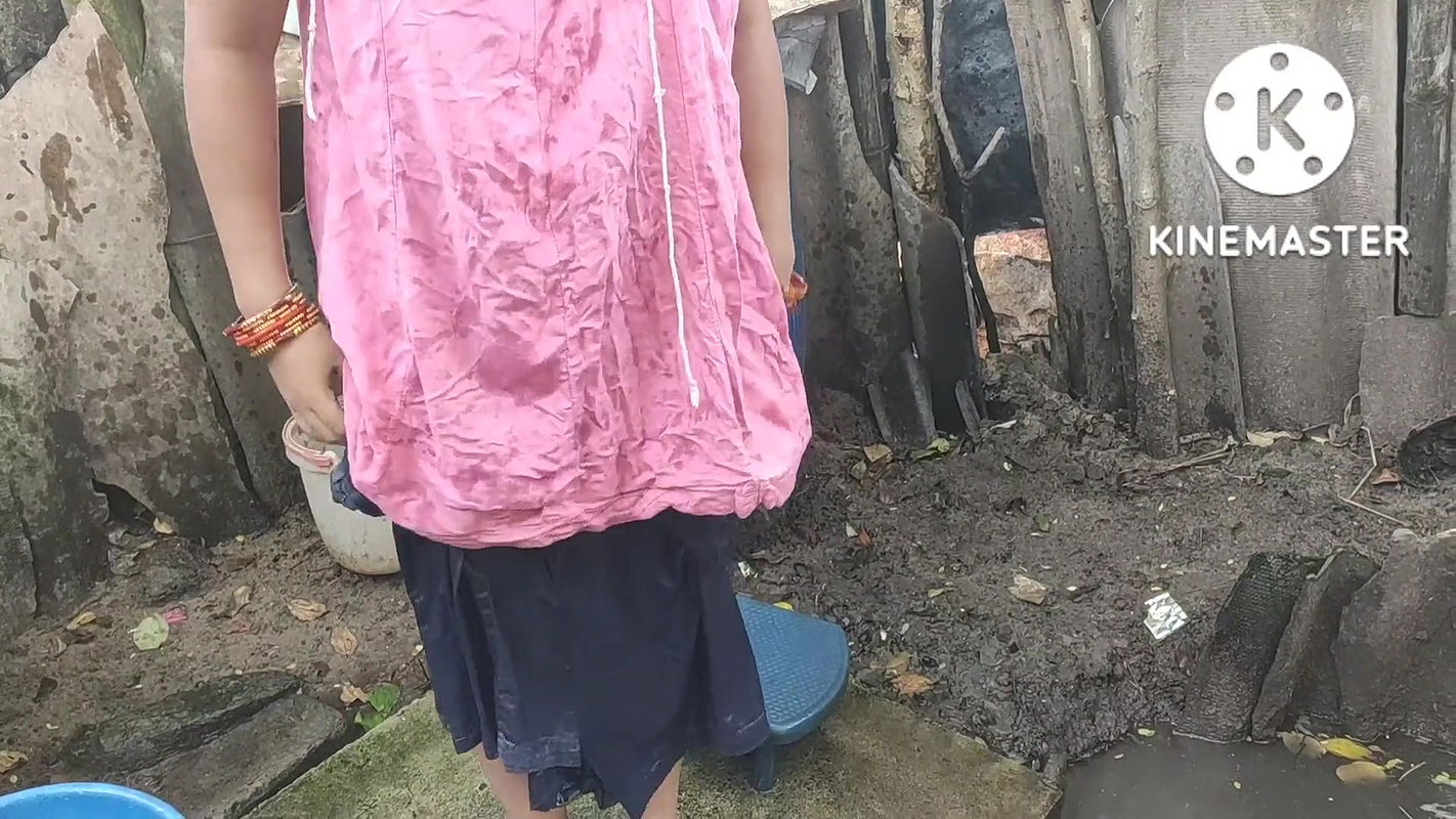 Indian house wife bathing outside