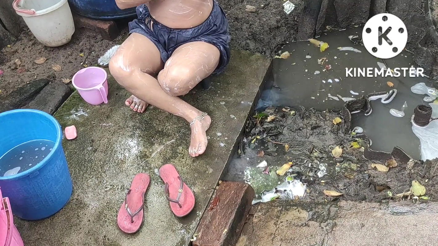 Indian house wife bathing outside