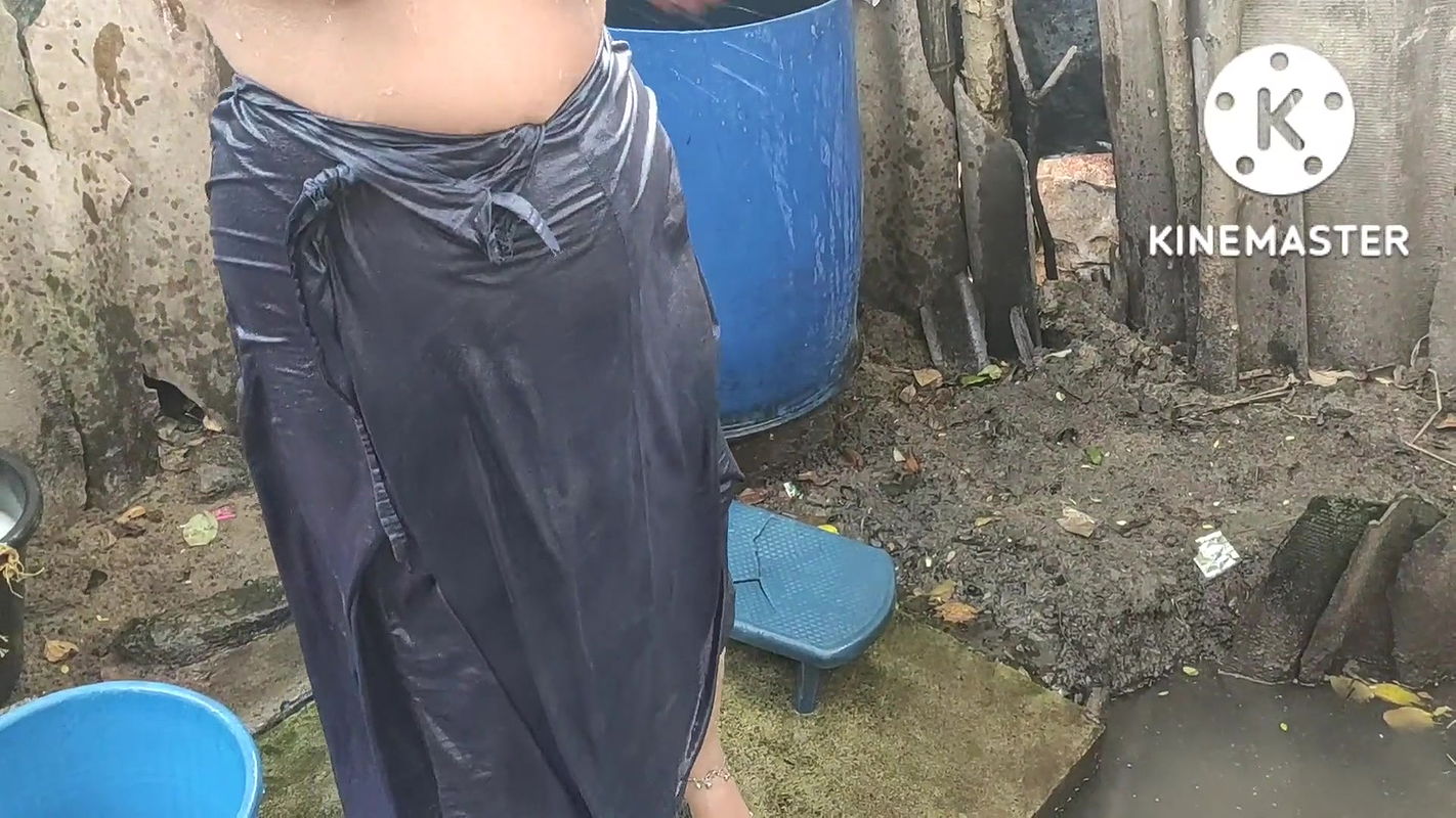 Indian house wife bathing outside