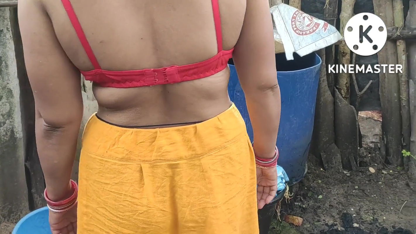 Indian house wife bathing outside