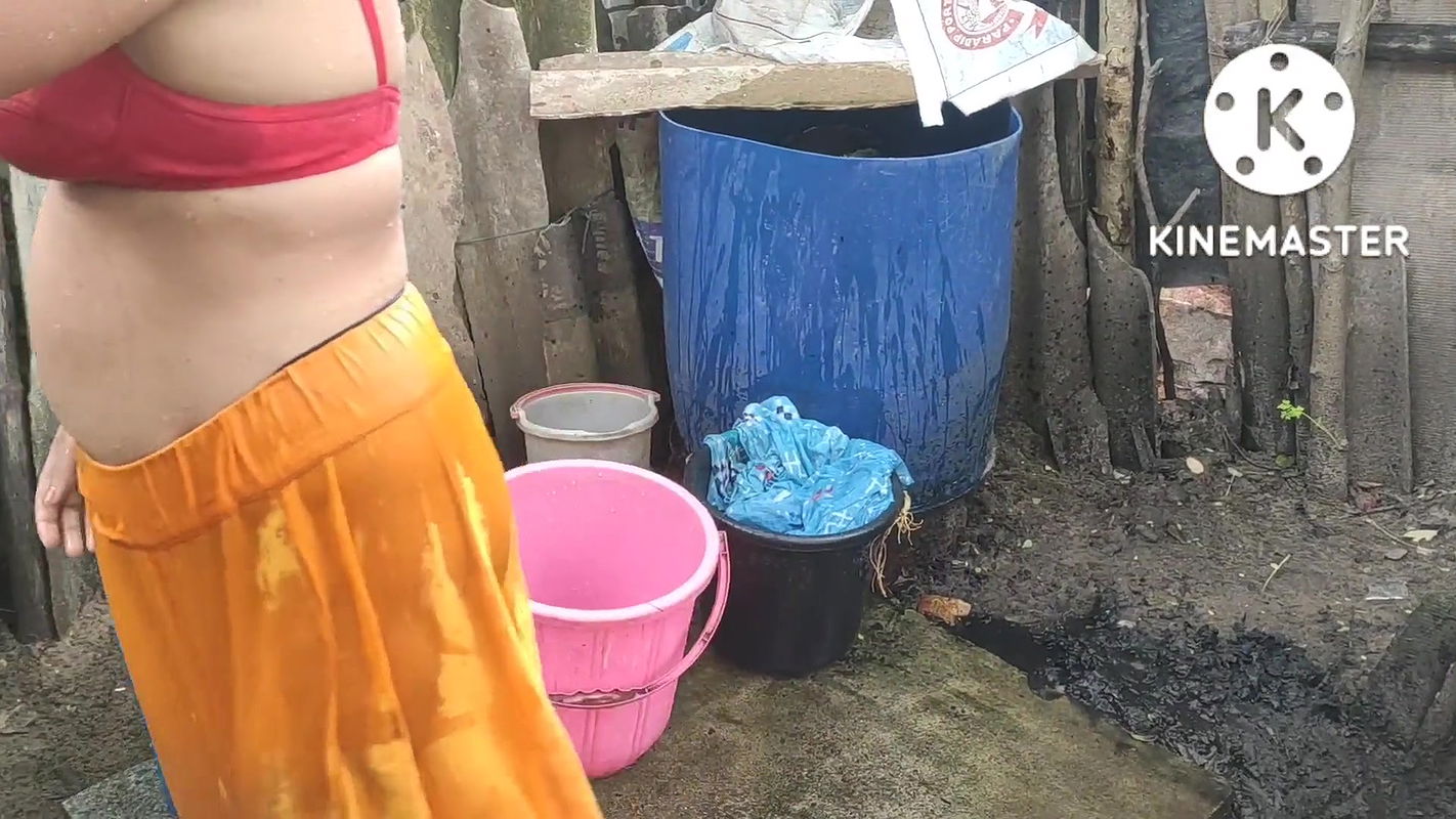 Indian house wife bathing outside