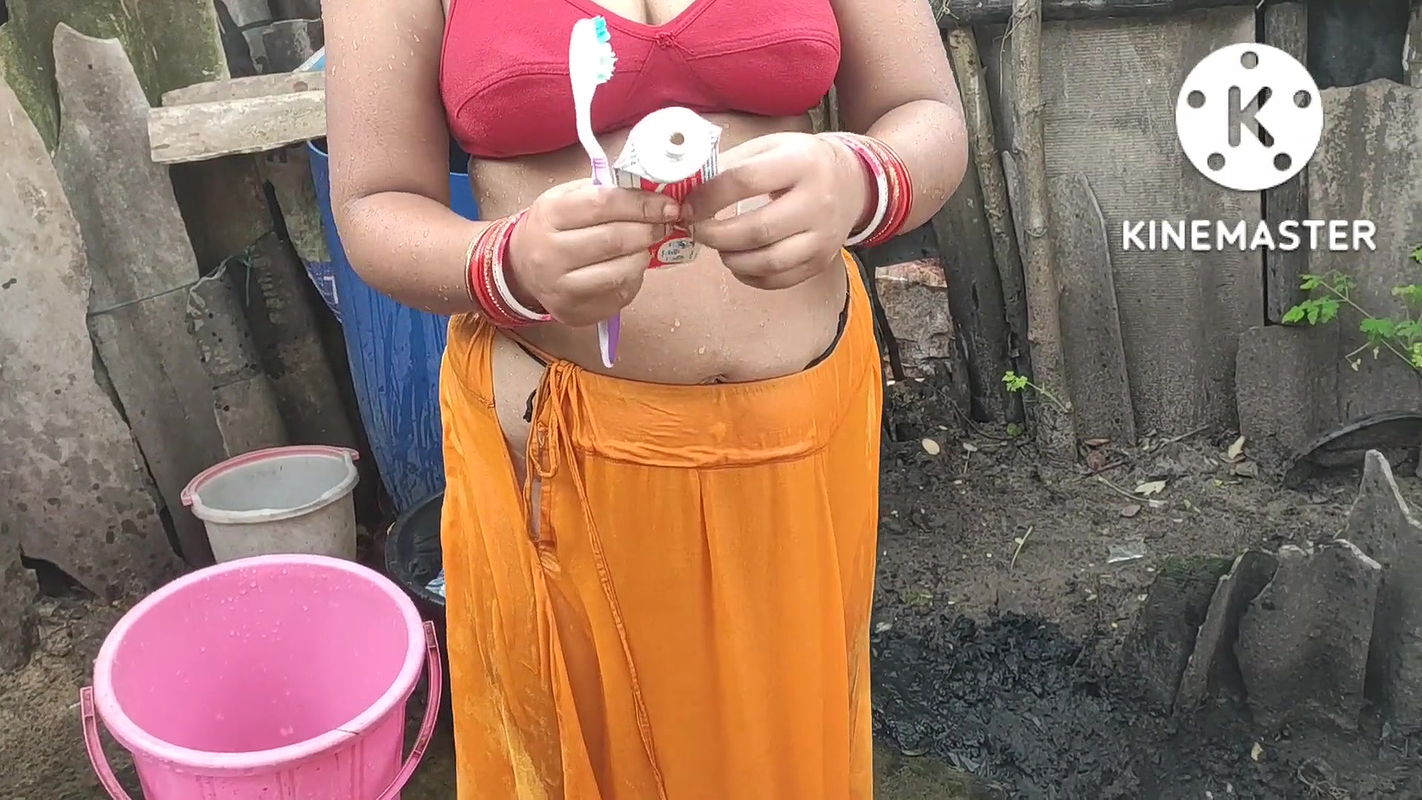 Indian house wife bathing outside