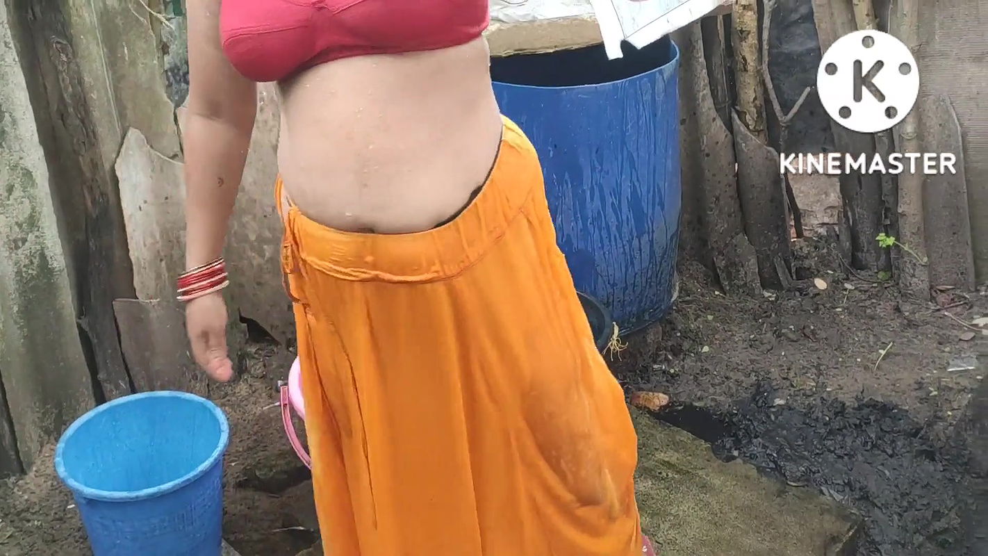 Indian house wife bathing outside