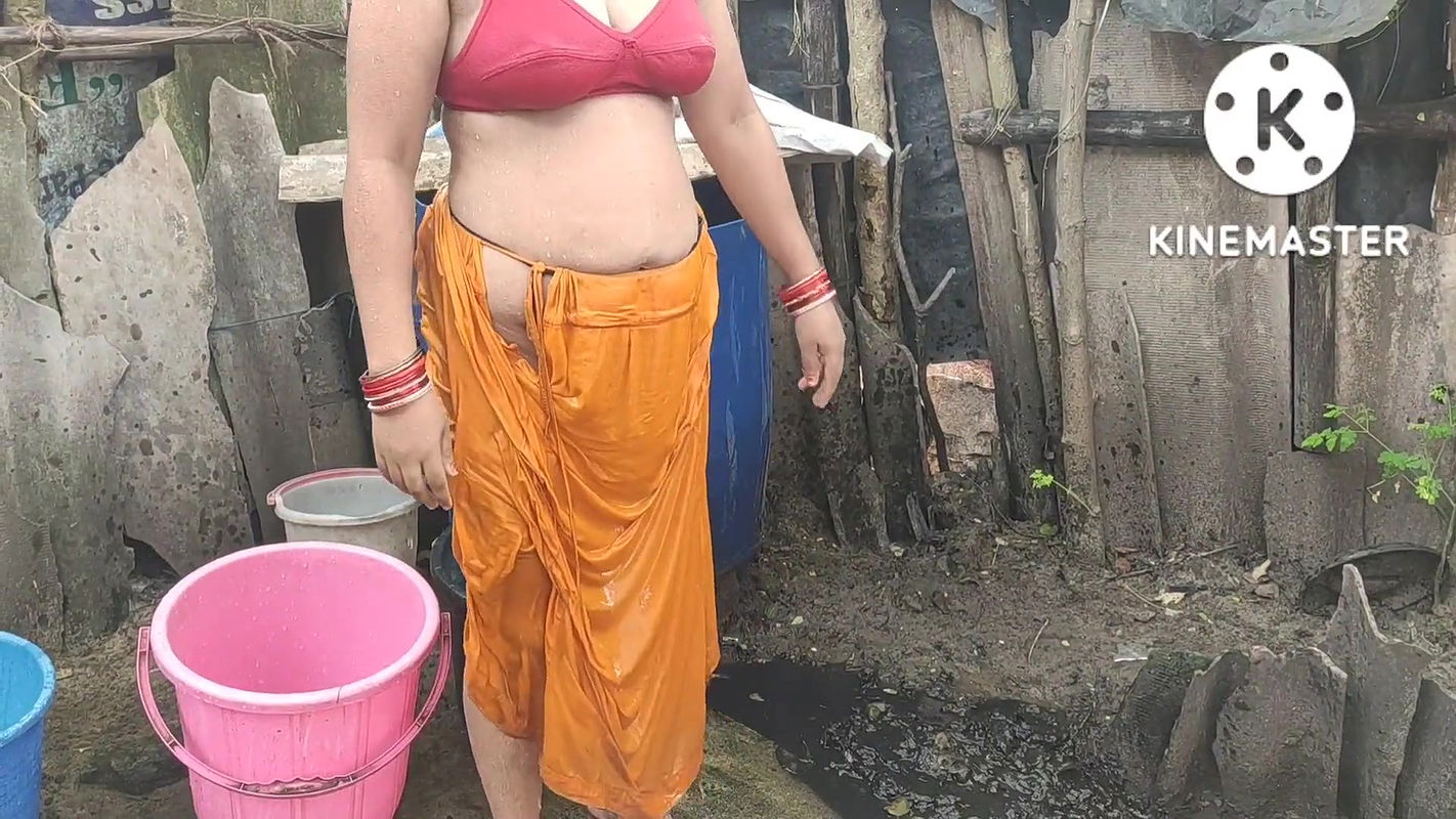 Indian house wife bathing outside