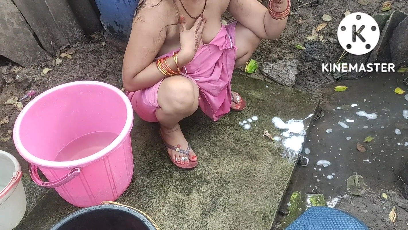 Indian house wife bathing outside