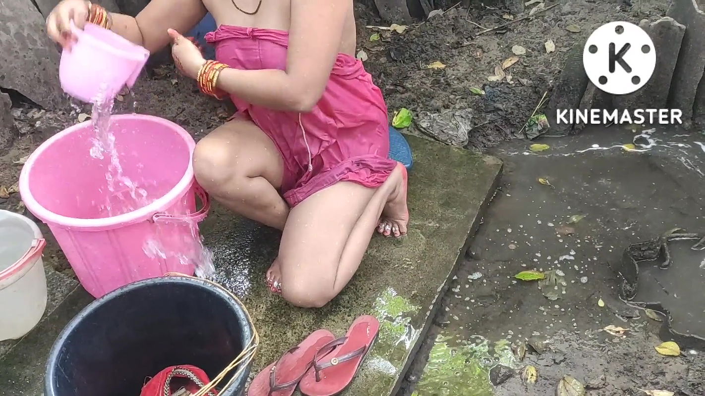 Indian house wife bathing outside