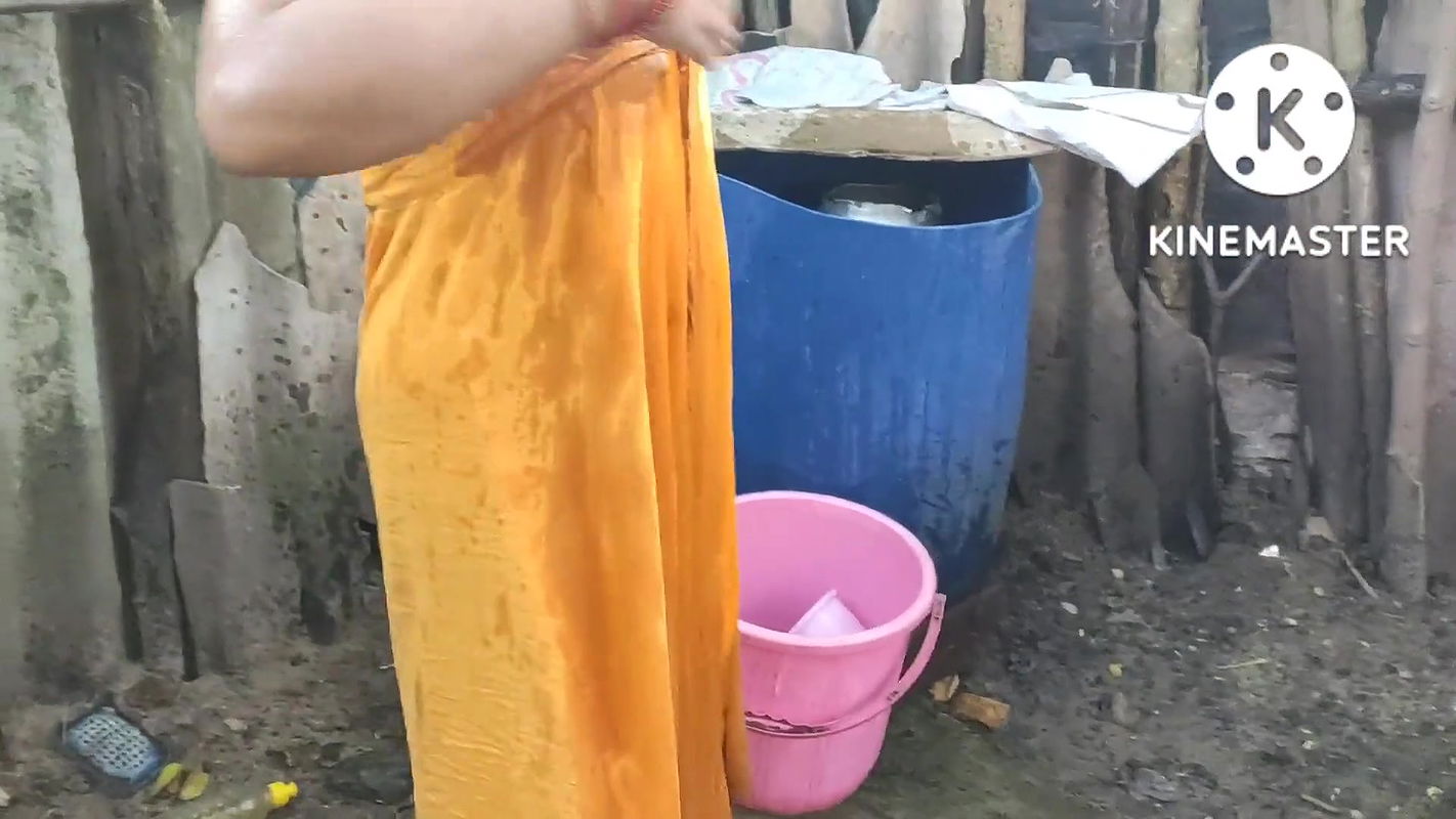 Indian house wife bathing outside