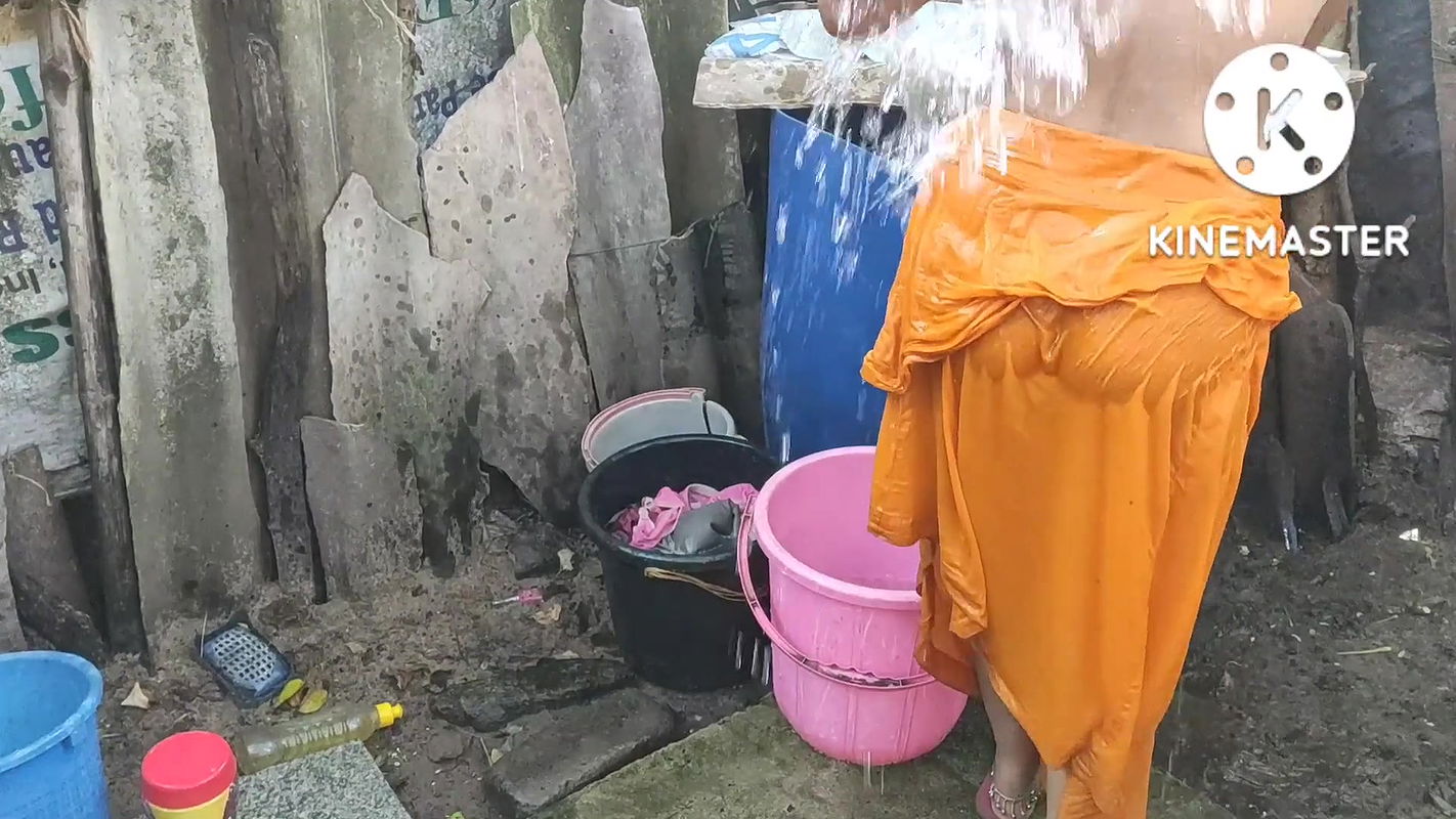 Indian house wife bathing outside