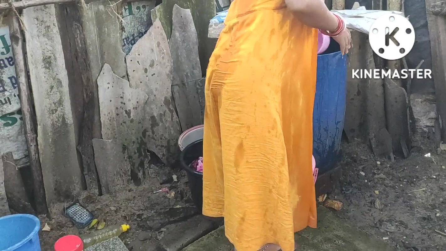 Indian house wife bathing outside