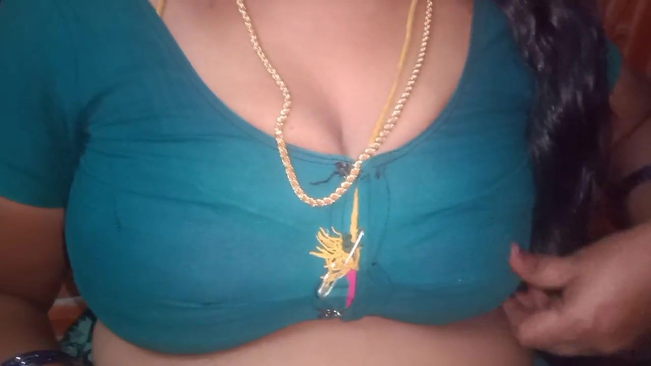 Tamil aunty squeezing her breasts when she is alone and unable to control her emotions.