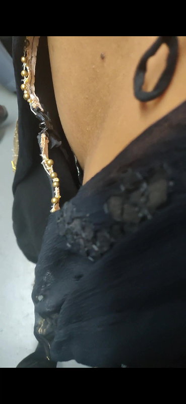 Desi woman bare back and black bra visible from top