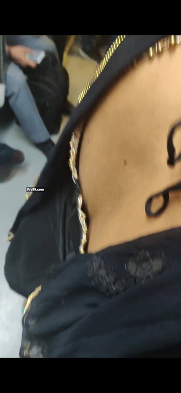 Desi woman bare back and black bra visible from top