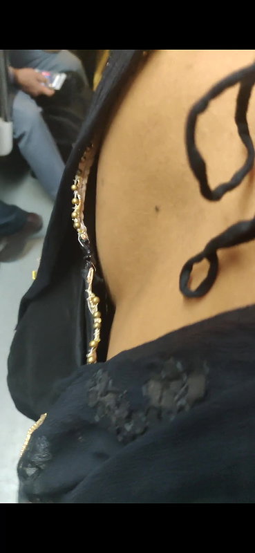 Desi woman bare back and black bra visible from top