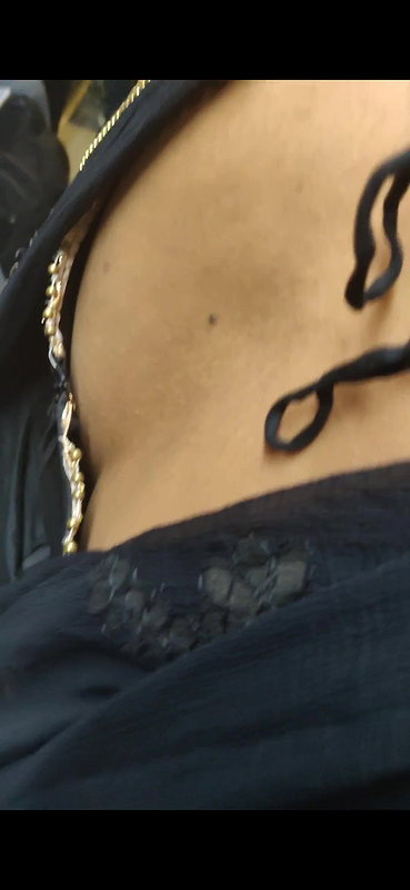Desi woman bare back and black bra visible from top