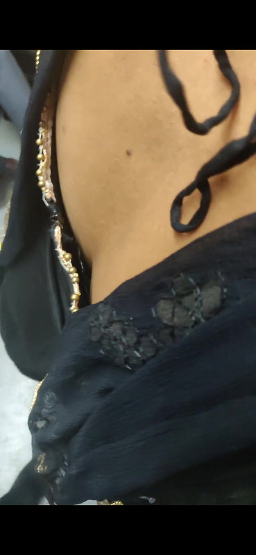 Desi woman bare back and black bra visible from top