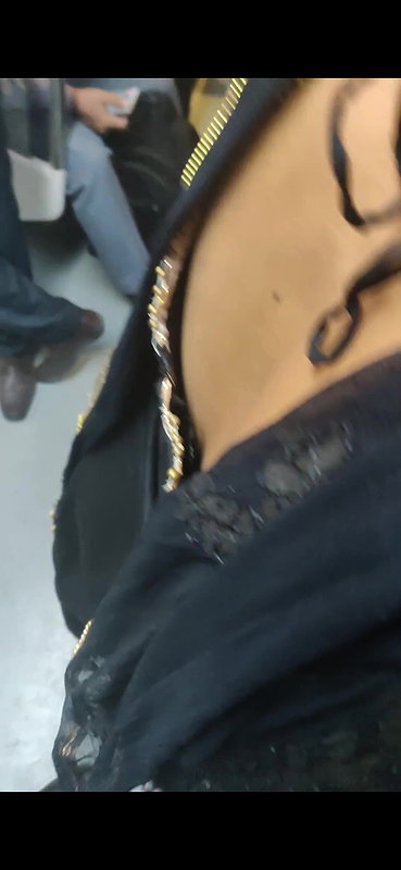 Desi woman bare back and black bra visible from top