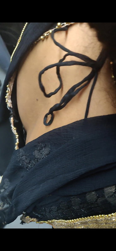 Desi woman bare back and black bra visible from top