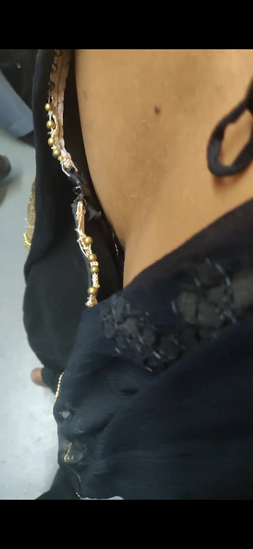 Desi woman bare back and black bra visible from top