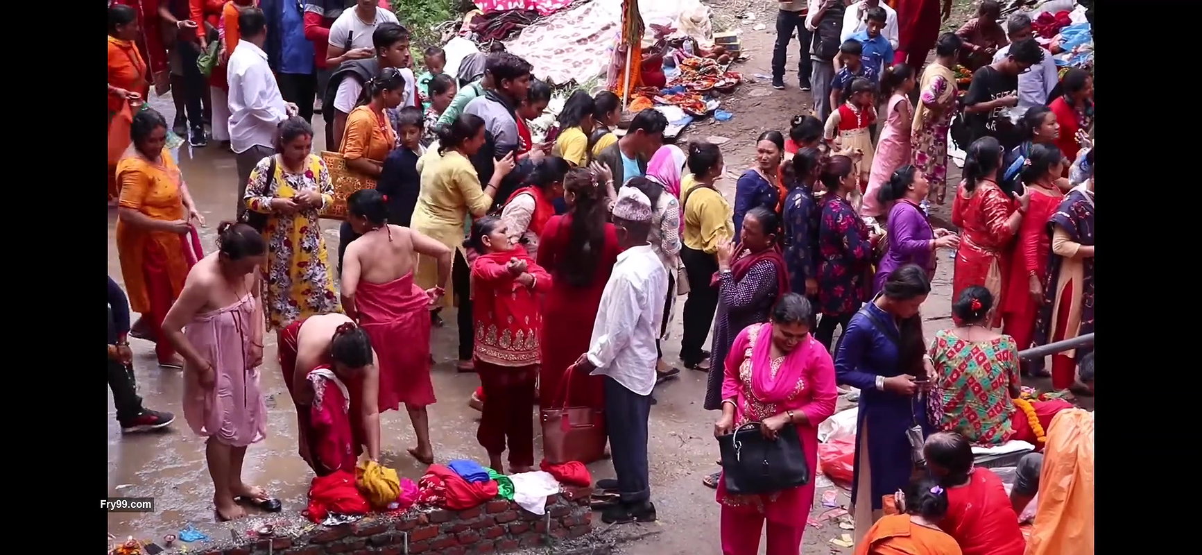 Multiple women wearing clothes after bath at ghat