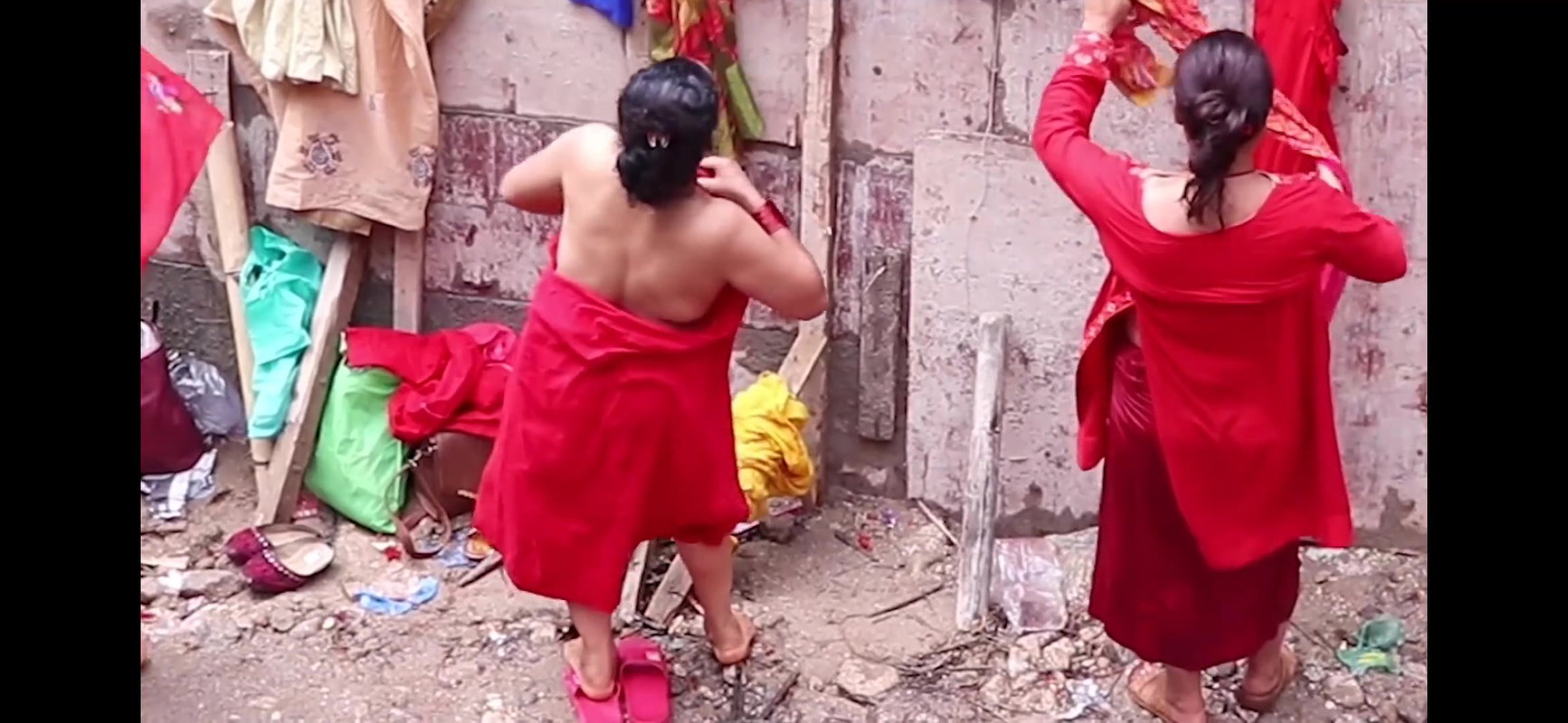 Multiple women wearing clothes after bath at ghat