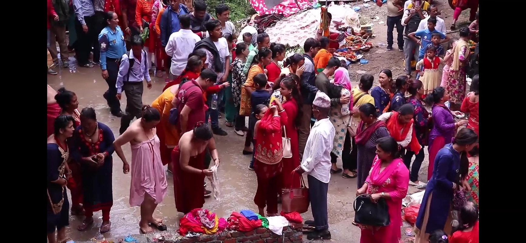 Multiple women wearing clothes after bath at ghat
