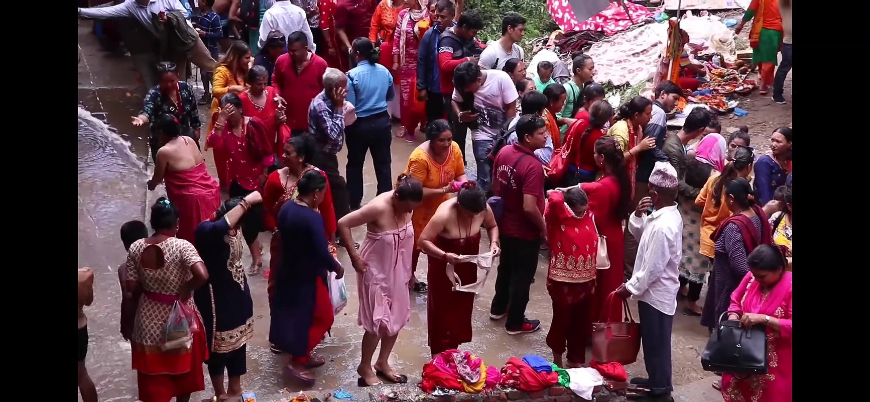 Multiple women wearing clothes after bath at ghat
