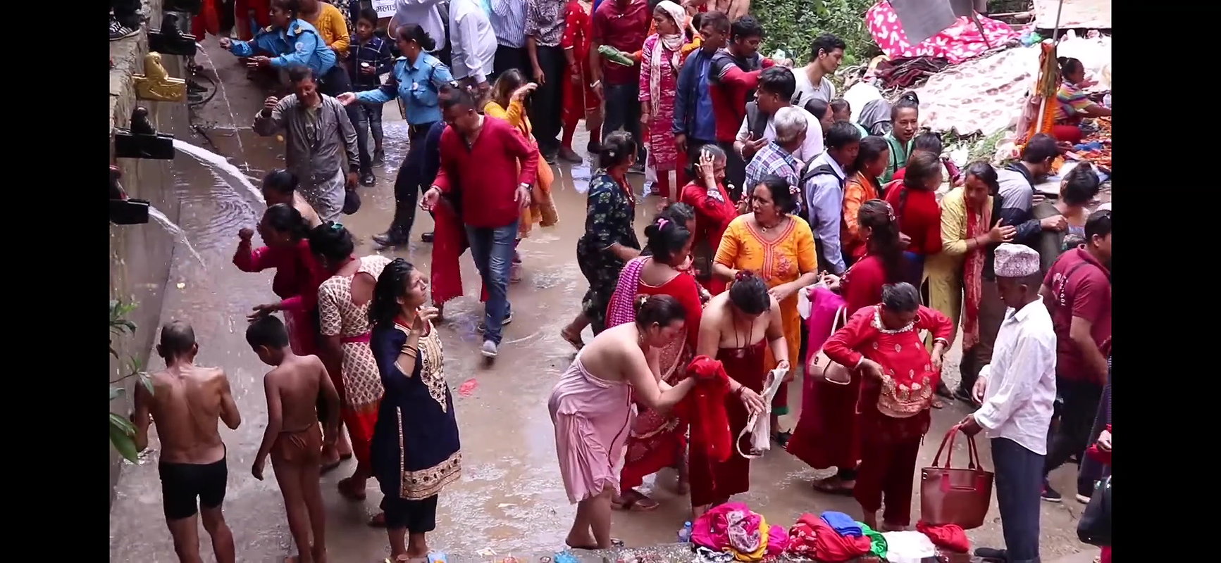 Multiple women wearing clothes after bath at ghat