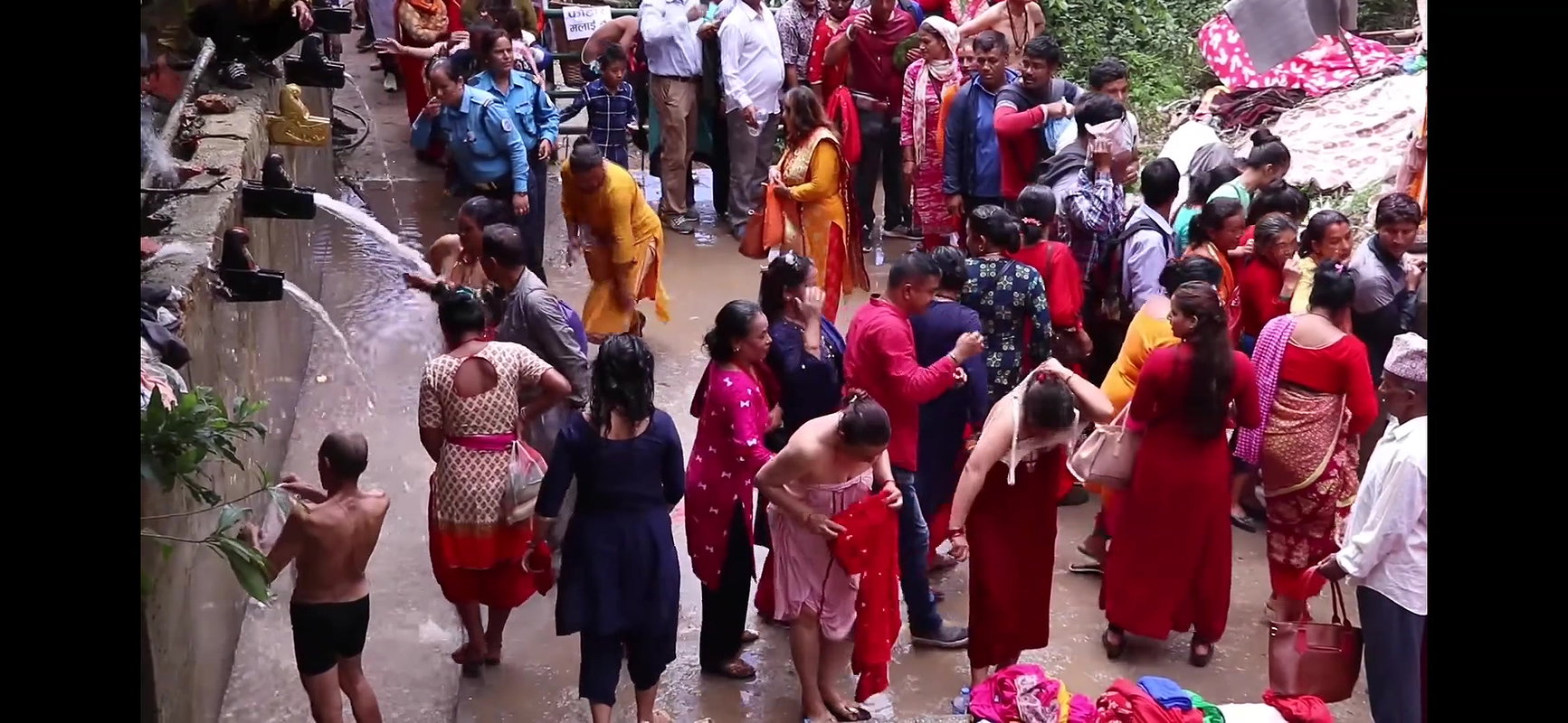 Multiple women wearing clothes after bath at ghat