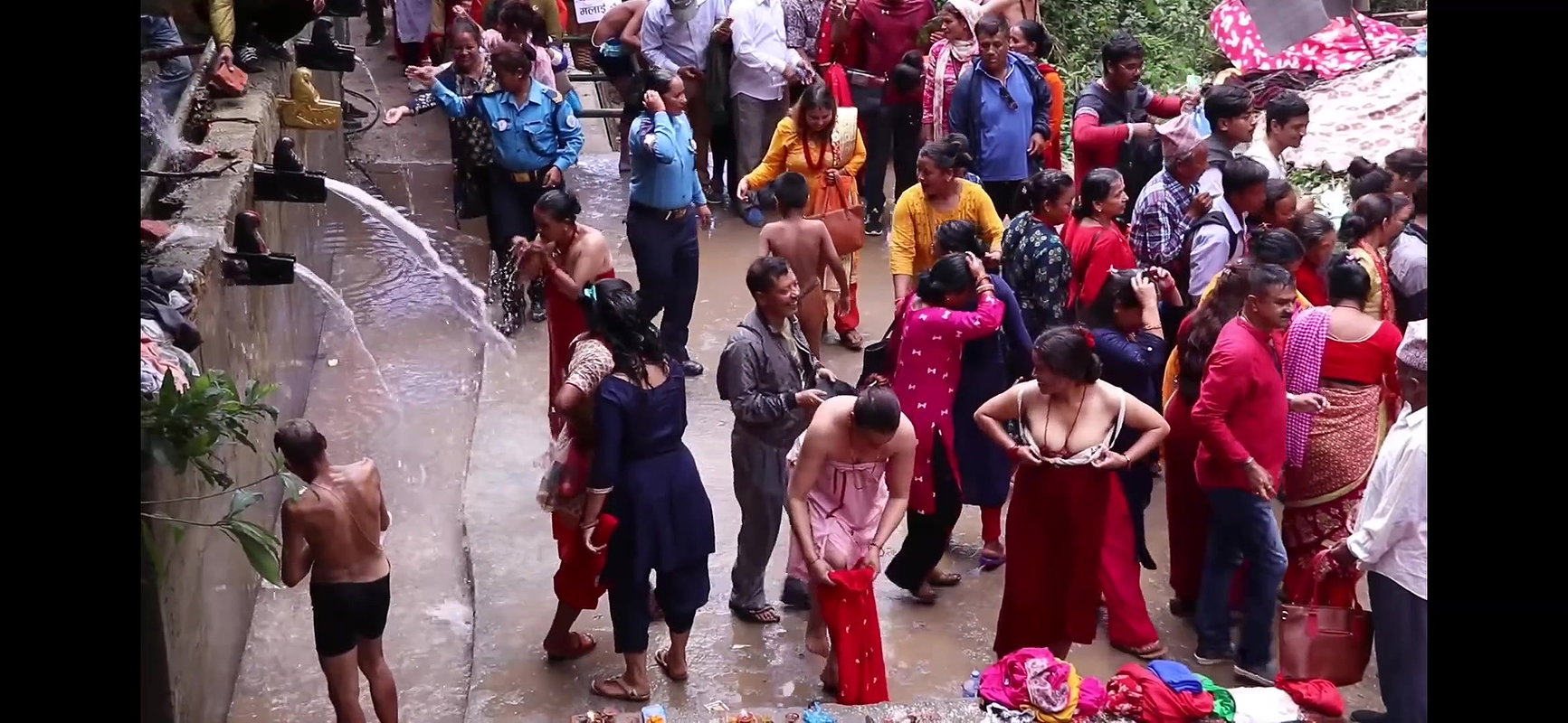 Multiple women wearing clothes after bath at ghat